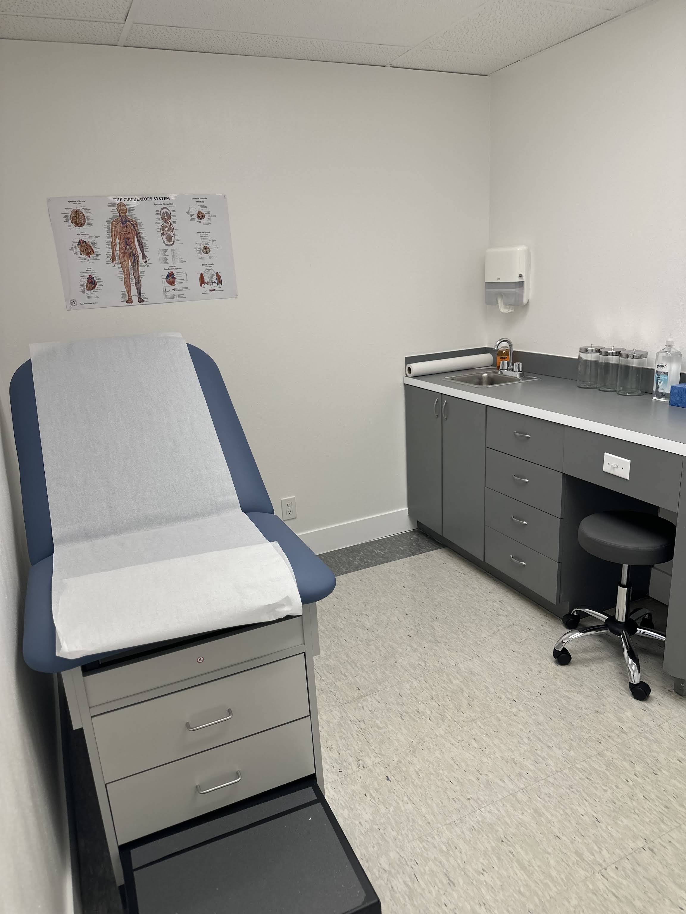 Exam room with standard diagnostic equipment